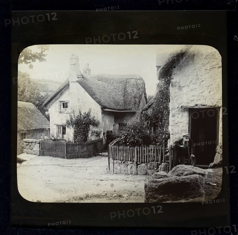 Magic lantern slide of white thatched village cottages in rural location possibly Wessex, England, UK circa 1900