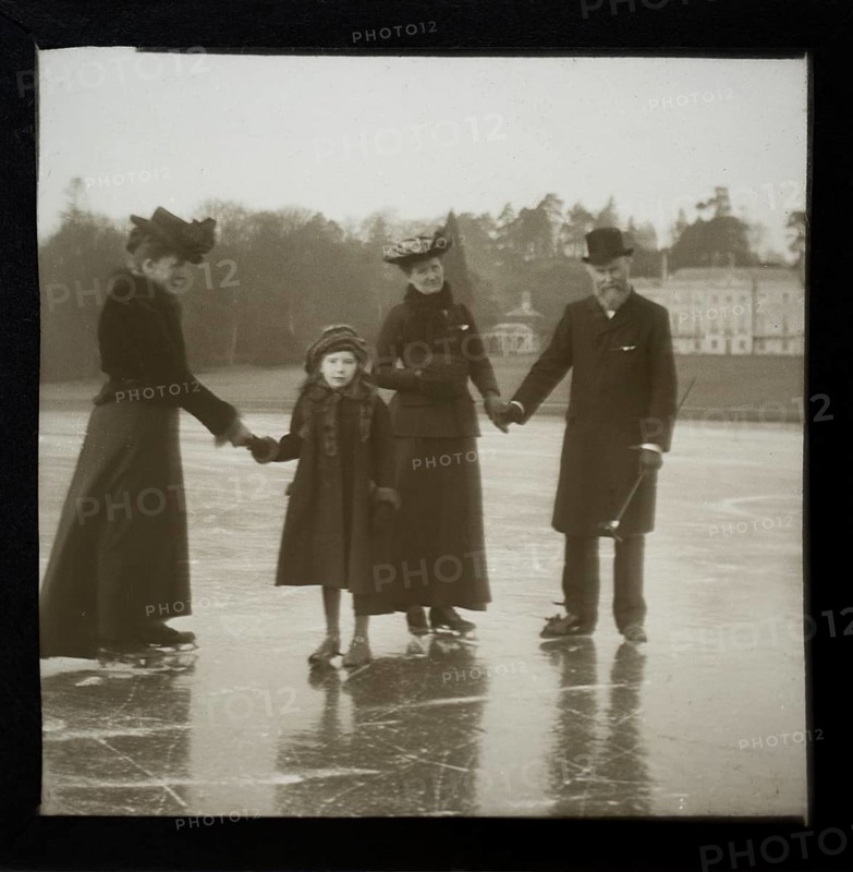 Magic lantern slide well-dressed middle class Edwardian family ice skating England, UK c 1900-1910
