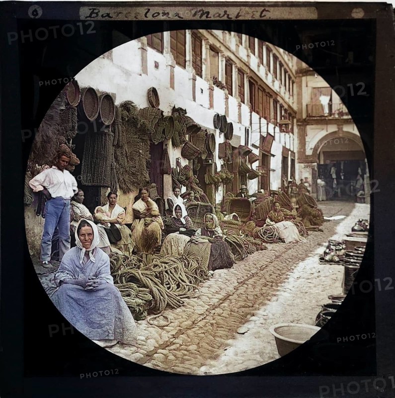 'Espartería en Almería' 1890 photographers Hermenegildo Otero and Miguel Aguirre, circular magic lantern slide mis-captioned as Barcelona, Spain. Women basket weavers and rope makers sitting in market place. Thought to be Cordoba