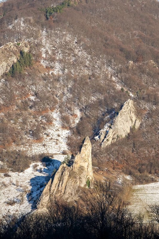 Cervenokamenské cliff (cervenokamenske bradlo), a huge rock with bushes, trees and meadows in winter, Vápec, Horná Poruba, Slovakia