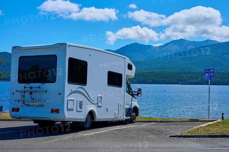 Motorhome in a car park overlooking a tranquil lake and mountains, Te Anau, Lake Te Anau, Southland District, South Island, New Zealand