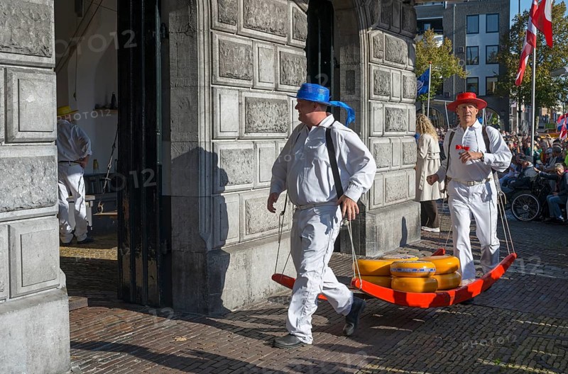 Men in traditional clothing transporting cheese at a historic building, cheese carrier, cheese, cheese market, former city scales, Alkmaar, Alkmar, Noord-Holland, North Holland, Netherlands