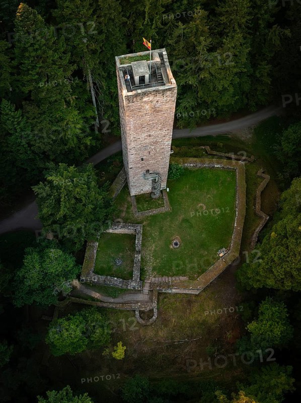 A tower and surrounding ruins hide in the middle of dense forests, seen from above, Mandelberg castle ruins, Pfalzgrafenweiler, Germany