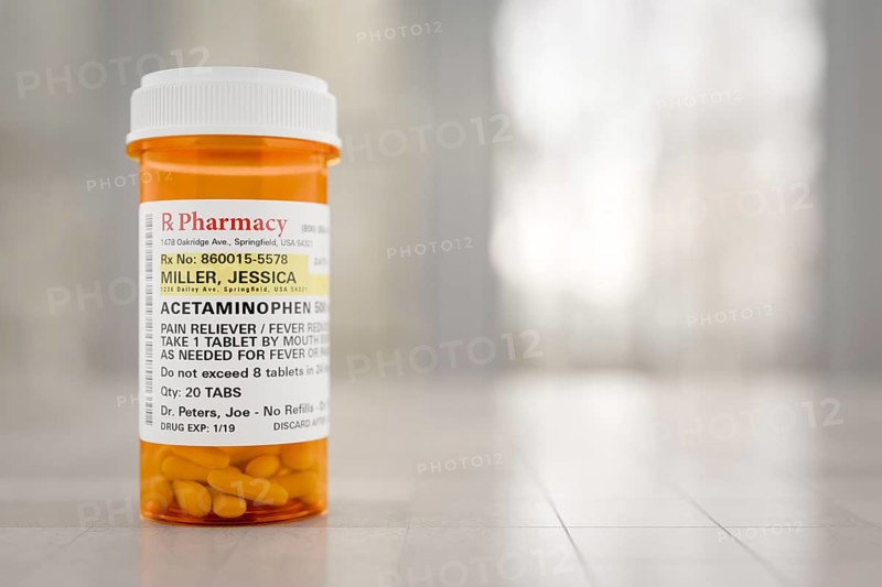 Acetaminophen prescription medicine bottle resting on A bathroom countertop. the label is non-proprietary, fictional, made specifically for the stock photo industry