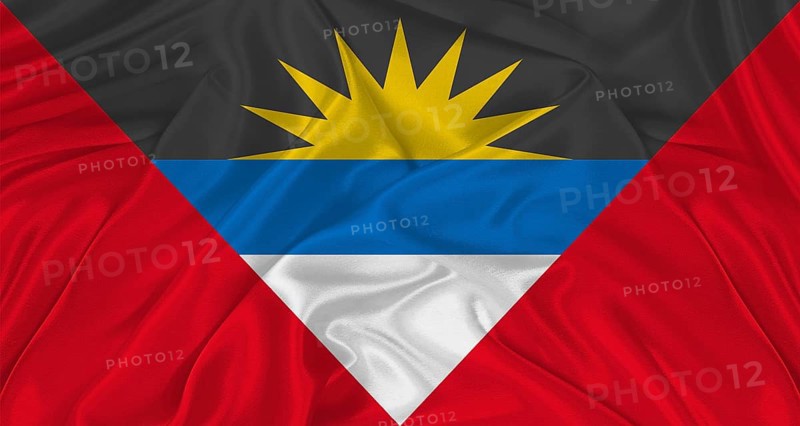 Antigua and Barbuda flag with cloth texture. Close up of Antigua and Barbuda flag waving