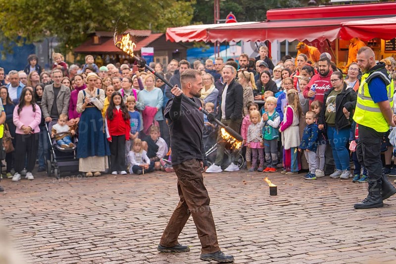 A fire juggler impresses the audience with his tricks on a busy square, Feuernacht, Sindelfingen, Germany