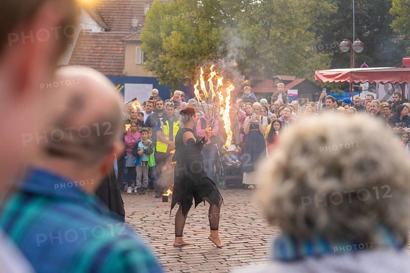 Dancer with burning torch, surrounded by an attentive audience at a street festival, Fire Night, Sindelfingen, Germany