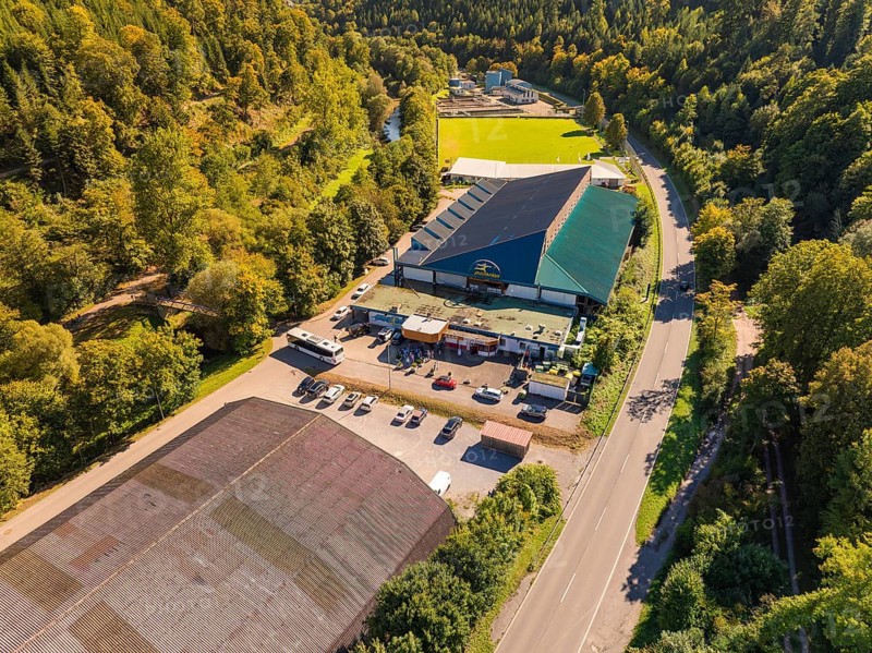Industrial building complex near a road in the countryside, large car park, sunny atmosphere, Polarion ice stadium, Bad Liebenzell, Black Forest, Germany