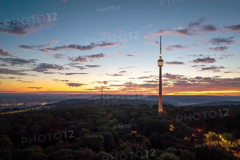 Television tower at dusk over forest and under dramatic sky, Stuttgart-Degerloch, Baden-Württemberg, Germany
