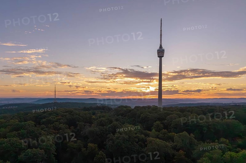 Sunrise behind a television tower in the forest with clouds in the sky, Stuttgart-Degerloch, Baden-Württemberg, Germany