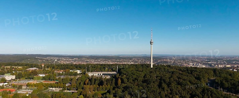 Panoramic view of a cityscape dominated by a television tower and surrounded by dense forests under a clear sky, Gazi Stadium, Stuttgart-Degerloch, Baden-Württemberg, Germany
