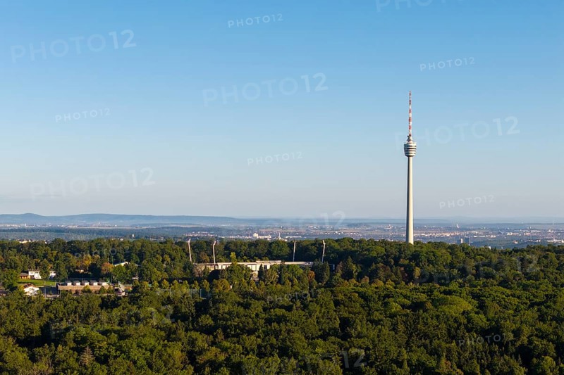 Stuttgart television tower rises above a forest with an urban backdrop on the horizon, Gazi Stadium, Stuttgart, Baden-Württemberg, Germany