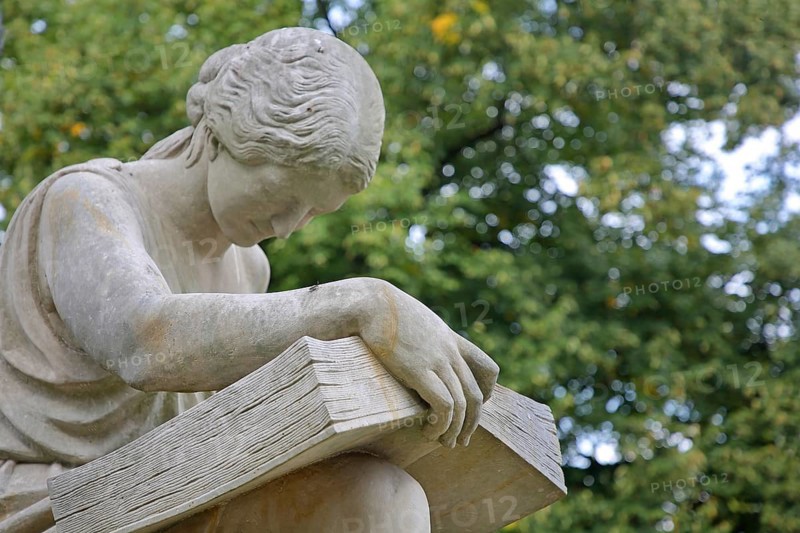 Seated white female figure reading a thick book as a symbol of science, allegory, knowledge, reading, monument to Lord Mayor Gustav Hasselbach, book reader, Hasselbach Fountain, Haydnplatz, Magdeburg