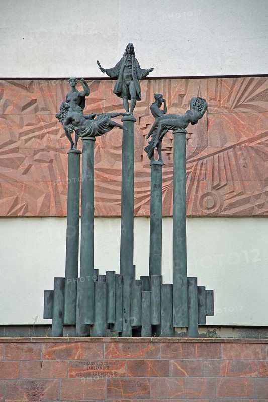 Telemann and the four temperaments by Eberhard Roßdeutscher 1981, monument to composer Georg Philipp Telemann, columns, arms, gestures, scroll, standing, bronze sculpture, modern art, Telemann monument, Magdeburg, Saxony-Anhalt, Germany