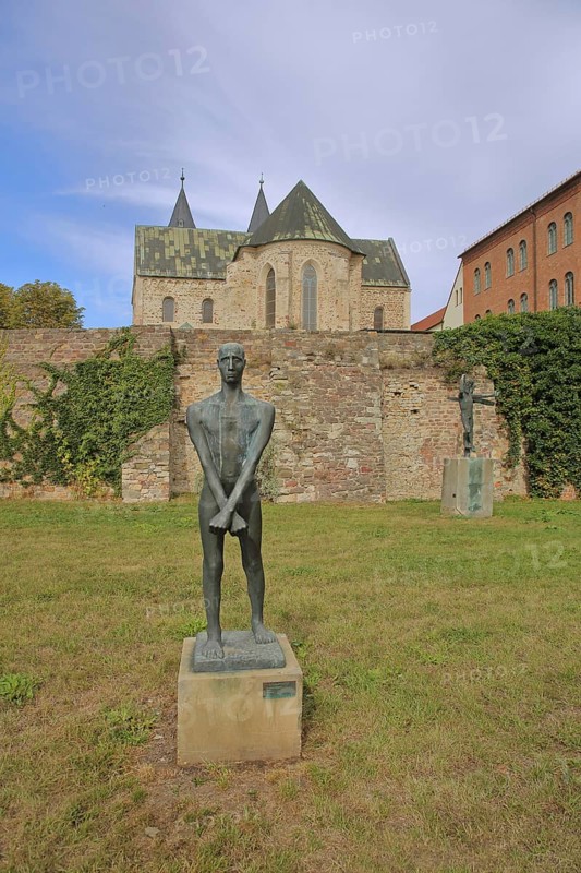 Sculpture Freedom Fighter by Fritz Cremer 1947, sculpture park, standing male figure with arms crossed, crossed over each other, crosswise, bronze sculpture, life-size, Romanesque, church, Monastery of Our Lady, art museum, sculpture park, Magdeburg, Saxony-Anhalt, Germany