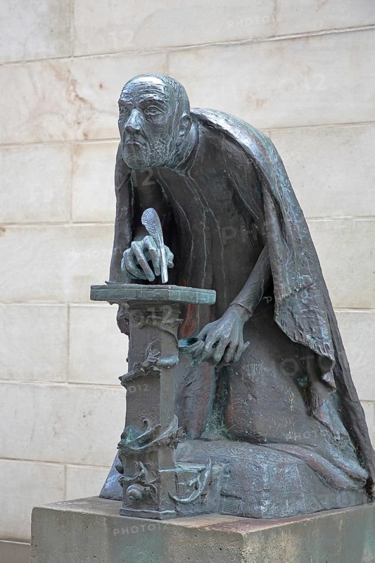 Albertus Magnus by Heinrich Apel 1985, medieval scholar and bishop writing with quill, view, bronze sculpture, monument, Magnus monument, St Peter's, Magdeburg, Saxony-Anhalt, Germany