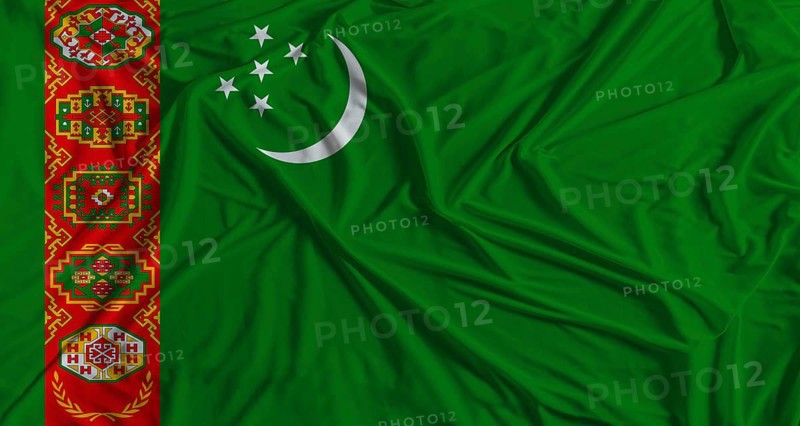 Turkmen flag with fabric texture background. National flag of Turkmenistan with cloth texture