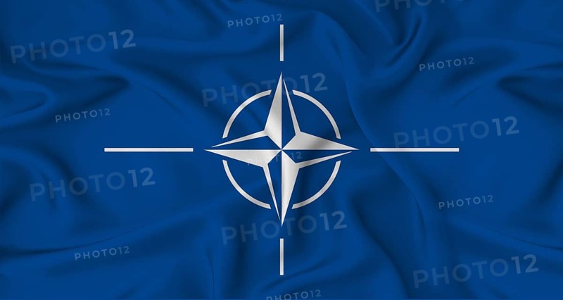 Realistic NATO flag waving. Close up of flag of NATO with cloth texture
