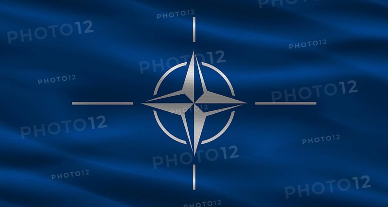 NATO flag with fabric texture. Realistic flag of NATO waving