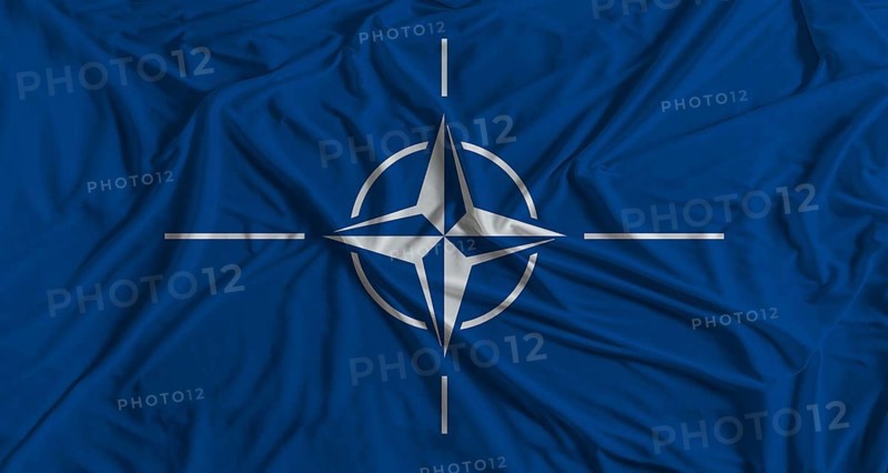 NATO flag with fabric texture background. National flag of NATO with cloth texture