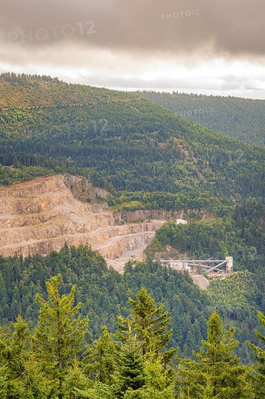 A quarry on a wooded hillside under a grey sky, Black Forest, Seebach, Germany