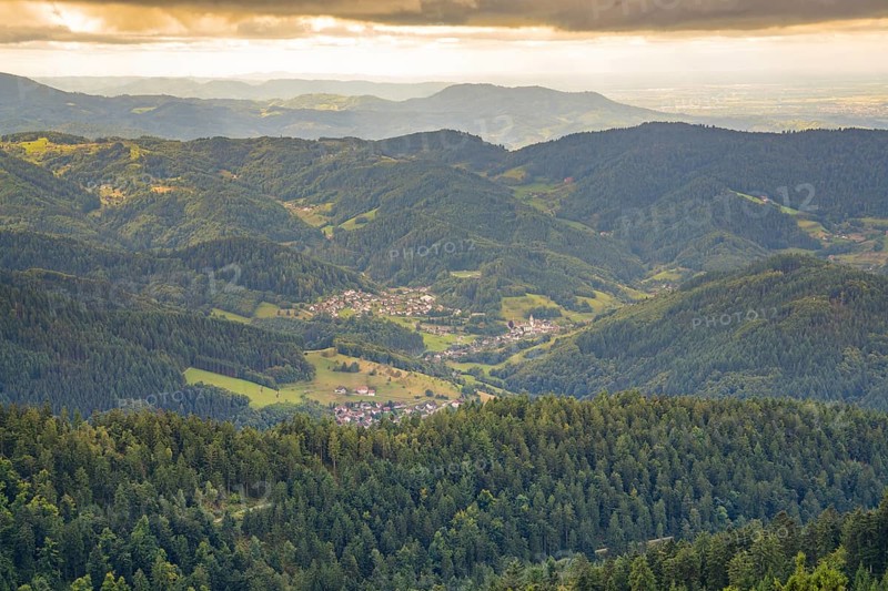 Overview of a village in a green hilly landscape at dusk, Black Forest, Seebach, Germany