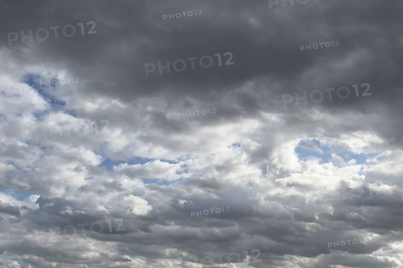 Large field of stratocumulus clouds, in the background altocumulus clouds under blue sky, international