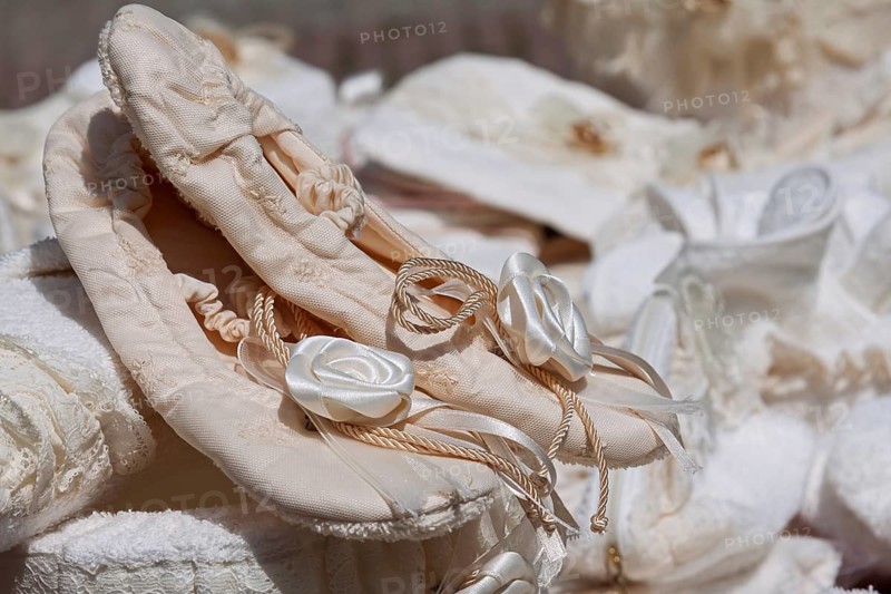 Satin ballet shoes with floral embellishment, embedded in a soft, romantic atmosphere, weekly market market, Tuscany, Italy