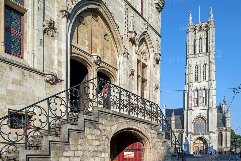 13th century Gothic St Bavo's Cathedral and entrance to the 14th century medieval belfry in the historic city centre of Ghent, East Flanders, Belgium