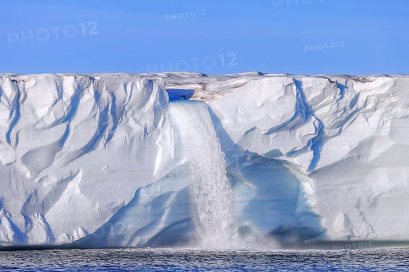 Waterfall at edge of the Brasvellbreen glacier from the ice cap Austfonna debouching into the Barents Sea, Nordaustlandet, Svalbard, Spitsbergen