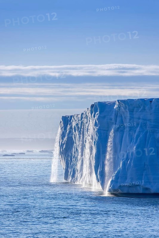 Waterfall at edge of Brasvellbreen glacier from the ice cap Austfonna pouring fresh water into the Barents Sea, Nordaustlandet, Svalbard, Spitsbergen