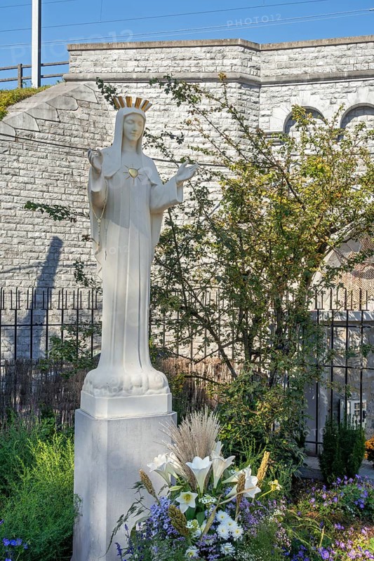 Hawthorn bush and statue of Virgin Mary in front of bridge at Our Lady of Beauraing, Notre-Dame de Beauraing sanctuary, province of Namur, Belgium