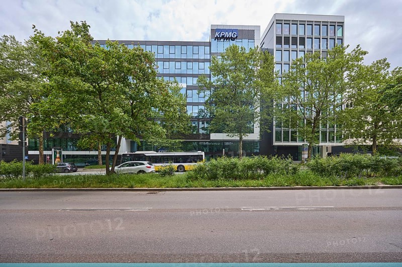 Auditing and management consultancy KPMG, modern architecture, street, public bus, trees, milky blue sky, diffuse light, Theodor-Heuss-Straße, Stuttgart, state capital, urban district of Stuttgart, Baden-Württemberg, Germany