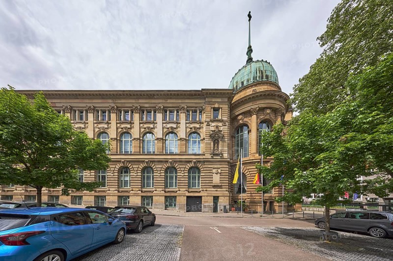 Haus der Wirtschaft Baden-Württemberg, conference centre, congress centre, historic building, architect Frederik Skjøld Neckelmann, street, car park, vehicles, flag, flagpoles, trees, milky blue sky, diffuse light, slightly sunny, Willi-Bleicher-Straße, Stuttgart, state capital, urban district of Stuttgart, Baden-Württemberg, Germany