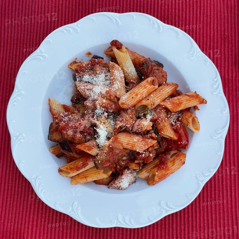 Classic Italian Sardinian vegetarian pasta dish with paste Penne rigate Melanzane aubergine passata di pomodoro Passed tomatoes and grated cheese Pecorino, international