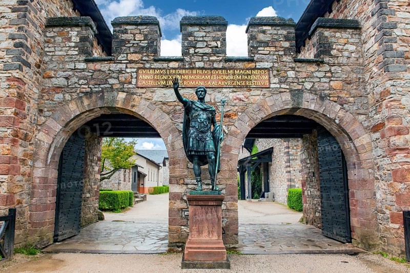 Statue of ancient Roman emperor Antoninus Pius with right arm raised to Roman salute Saluto romano in front of main portal entrance to reconstructed Roman fort Saalburg, Bad Homburg, Hesse, Germany