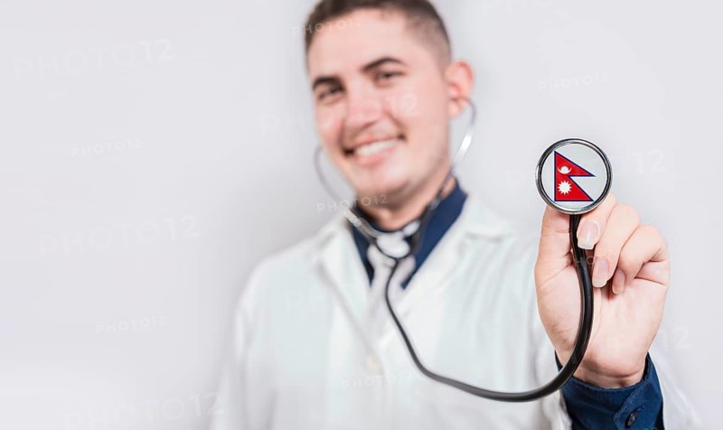 Doctor showing stethoscope with Nepal flag. Nepal national healthcare concept