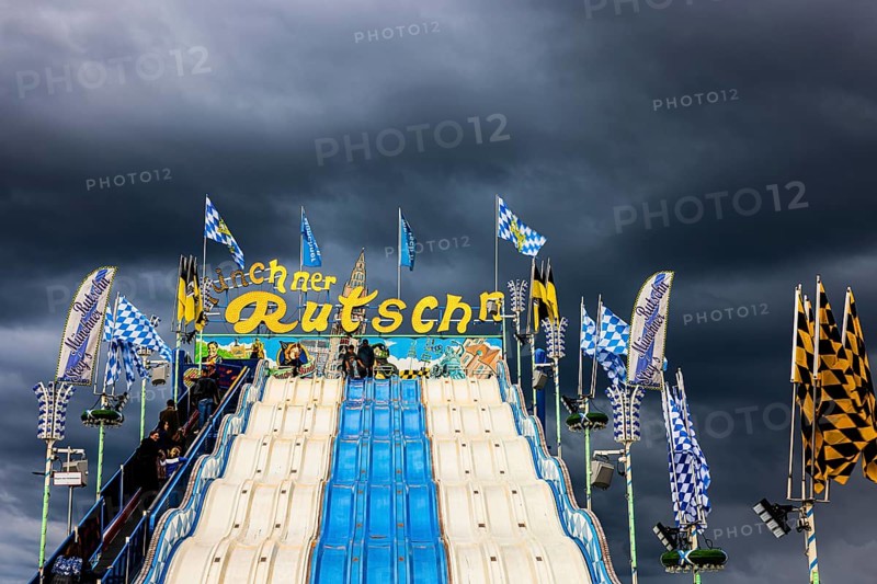 Dark clouds over the Oktoberfest attraction Münchner Rutschn, Festwiese, Theresienwiese, Oktoberfest, Munich, Upper Bavaria, Bavaria, Germany