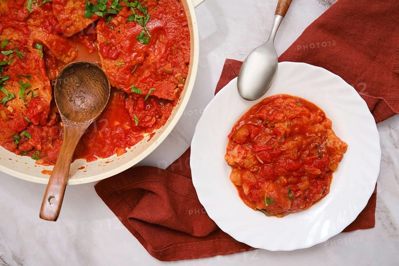 Close-up overhead view of Italian tomato and bread soup Pappa al pomodoro in a pot and a plate