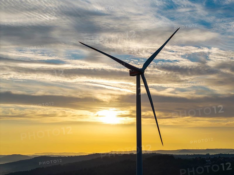 A single wind turbine stands majestically against a breathtaking sky at sunrise, near Schorndorf, Remstal, Rems-Murr-Kreis, Baden-Württemberg, Germany