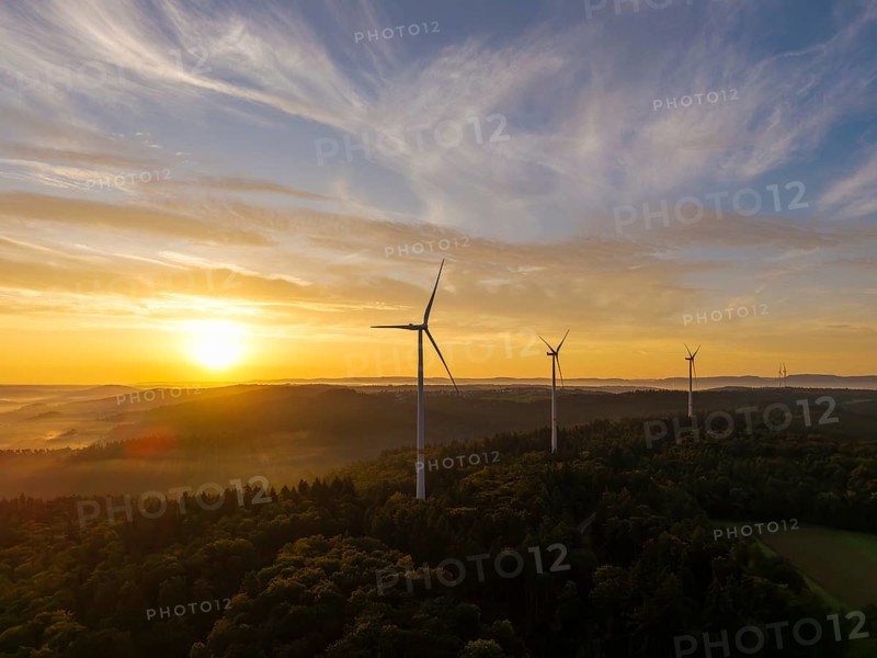 Wind turbines at dusk over wooded hills, the light gently breaking through the clouds, near Schorndorf, Rems-Murr-Kreis, Rems-Murr-Kreis, Baden-Württemberg, Germany