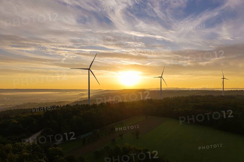 Wind turbines stretch across fields in the gentle sunlight that creates a peaceful horizon, near Schorndorf, Rems-Murr-Kreis, Rems-Murr Valley, Baden-Württemberg, Germany