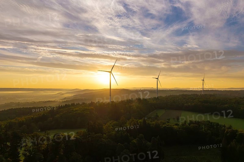 Three wind turbines above a hilly landscape, morning clouds reflecting the rising sunlight, near Schorndorf, Rems-Murr district, Rems-Murr-Kreis, Baden-Württemberg, Germany