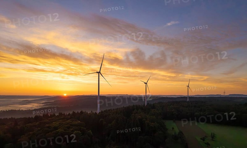 Three wind turbines at sunrise over a misty and golden landscape, near Schorndorf, Remstal, Rems-Murr-Kreis, Baden-Württemberg, Germany