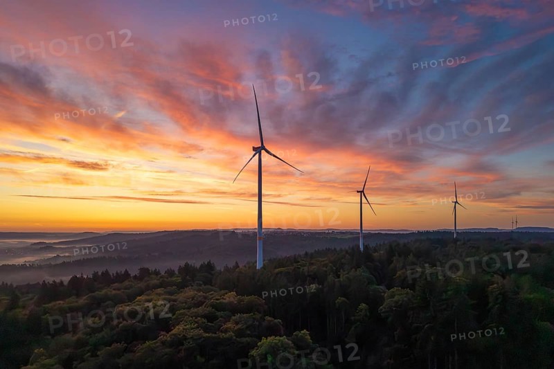 Three wind turbines in the foreground of a colourful morning sky over a hilly landscape, near Schorndorf, Remstal, Rems-Murr-Kreis, Baden-Württemberg, Germany