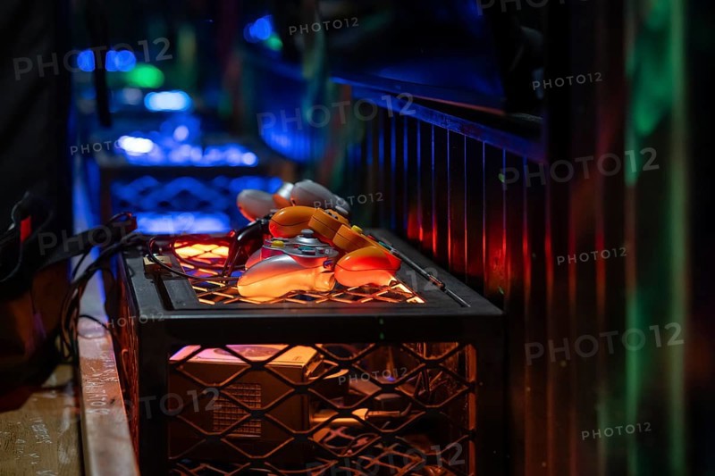 Orange-coloured gaming controllers, futuristic and tech-savvy atmosphere, arcade, Soho, London, England, United Kingdom