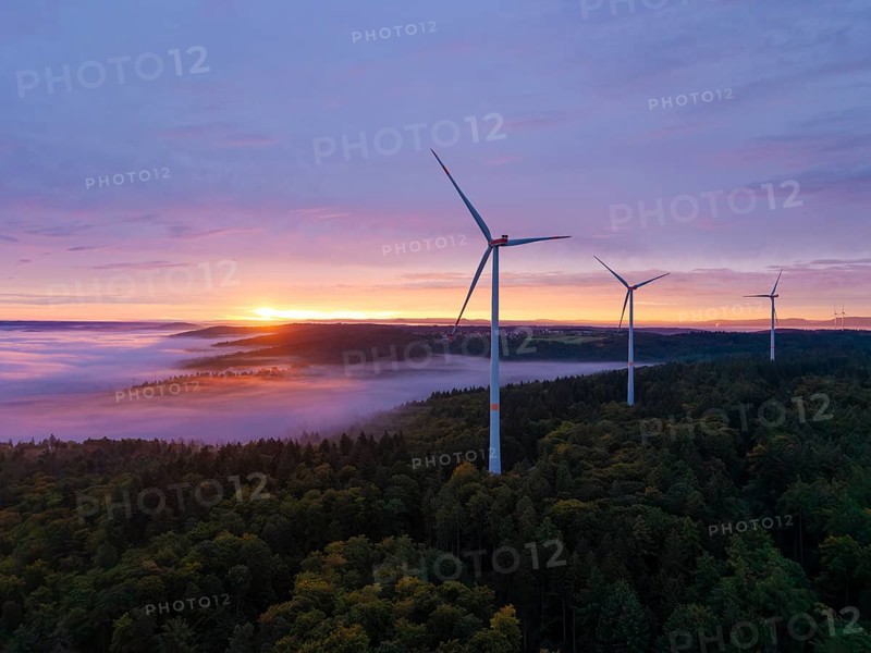 Wind turbines above a colourful forest landscape at dawn, sunrise, near Schorndorf, Remstal, Rems-Murr-Kreis, Baden-Württemberg, Germany