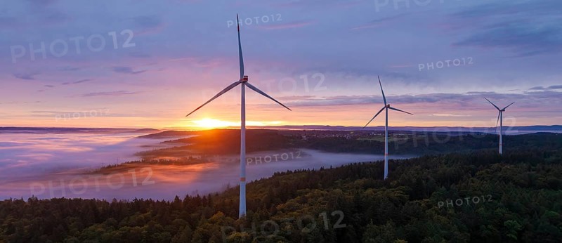 Powerful wind turbines over a misty forest and a wide horizon at sunrise, near Schorndorf, Rems-Murr-Kreis, Rems-Murr-Kreis, Baden-Württemberg, Germany