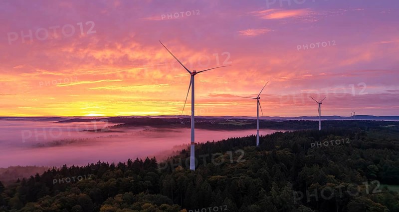 Wind turbines above a forest in front of sunrise with dramatic cloud formation, near Schorndorf, Remstal, Rems-Murr-Kreis, Baden-Württemberg, Germany