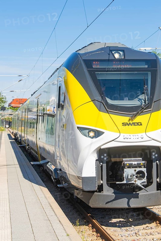 Modern white and yellow train on the track in sunny weather, taken from the side, battery Electric train with green electricity, Siemens Mireo Plus B, Freudenstadt, Germany